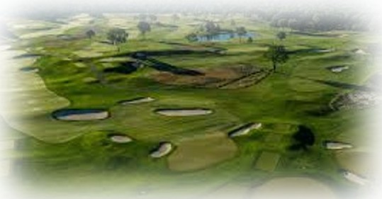 Aerial view of a golf course highlighting the course and surrounding landscape